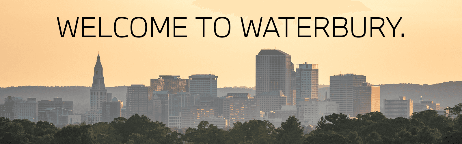 Welcome To Waterbury messaging spanning across the cityscape skyline.