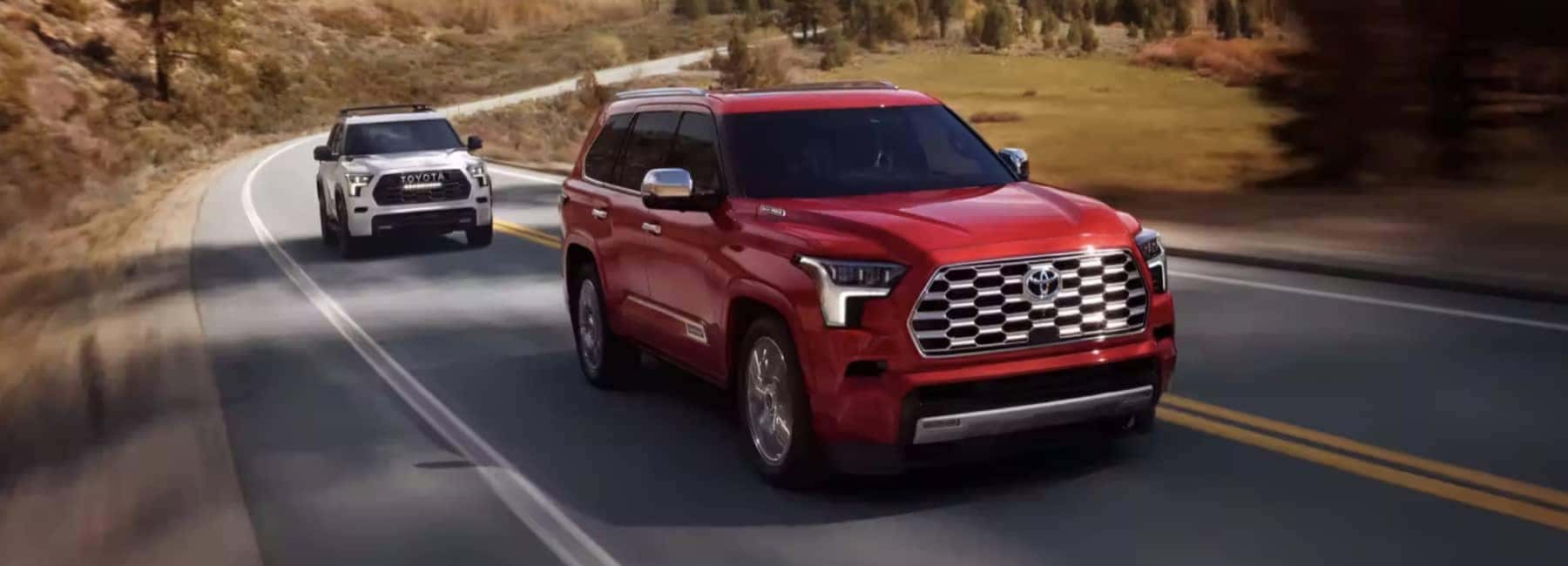 2024 Red Toyota Sequoia driving on a road