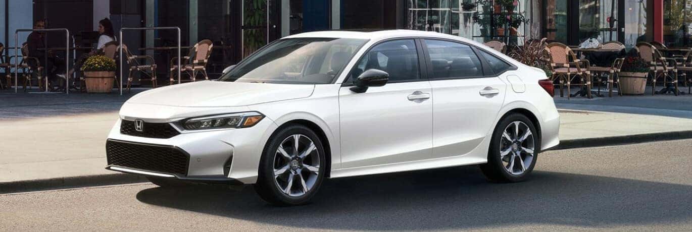 Exterior side view of a white Honda Civic parked in front of a cafe.