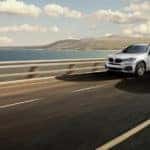 Image of two cars driving alongside highway 5 in Carlsbad.