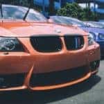 Parked BMW set aside other parked BMW vehicles in a crowded parking lot.