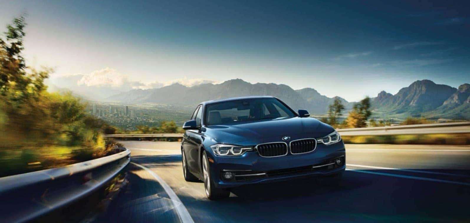 BMW Sedan driving through hillside