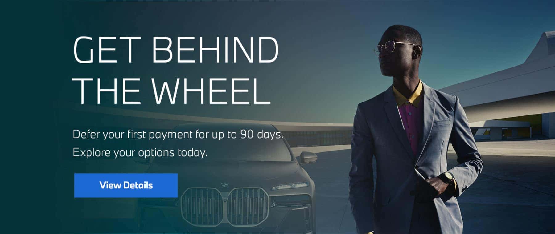 Male model in front of parked BMW Sedan.