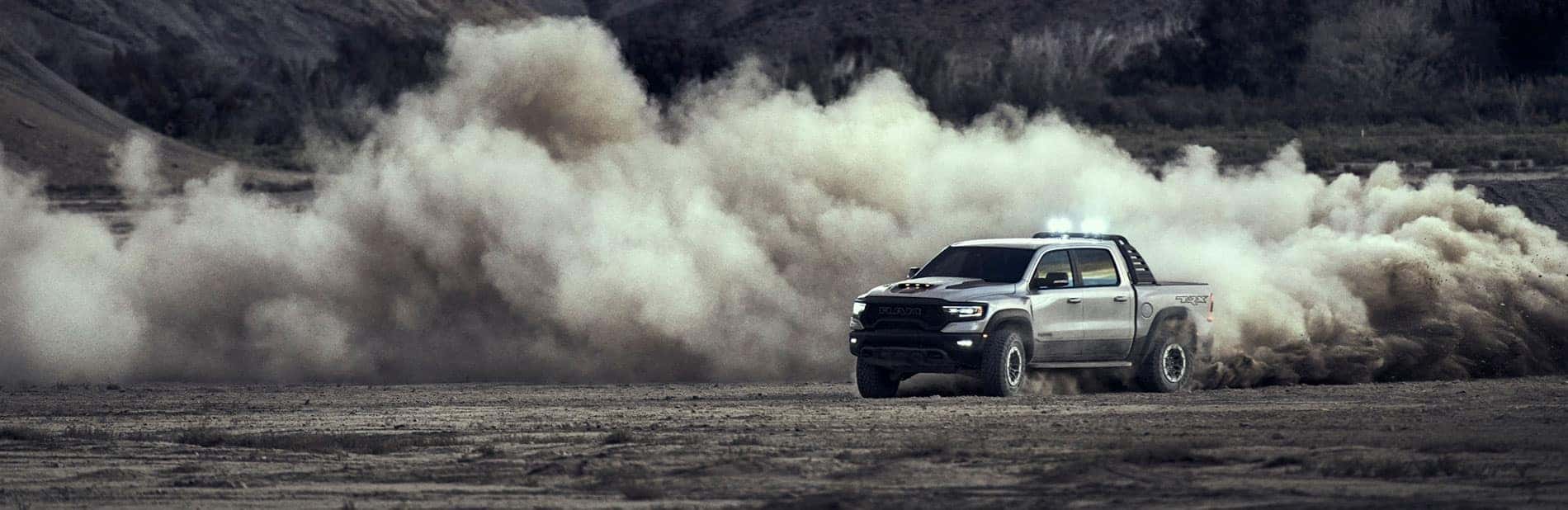 RAM TRX speeding with a dust cloud around it