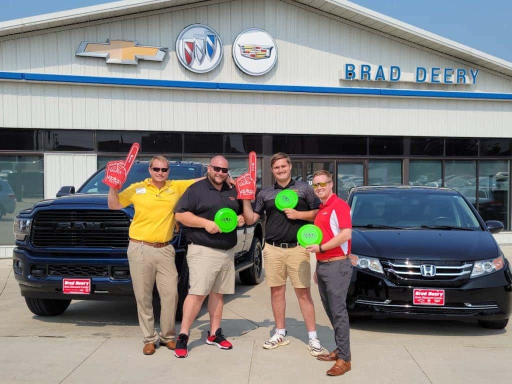 Deery Employees holding giveaway items for Kids day at the fair.