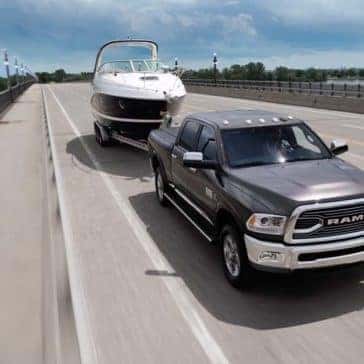 2018 Ram 2500 Limited towing a boat down highway