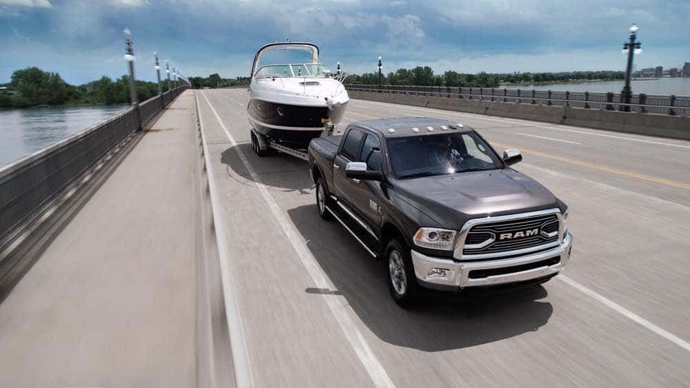 2018 Ram 2500 Limited towing a boat down highway
