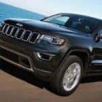 2019 Jeep Grand Cherokee towing boat on highway