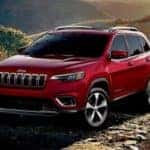 Red 2019 Jeep Cherokee Parked on Rocks