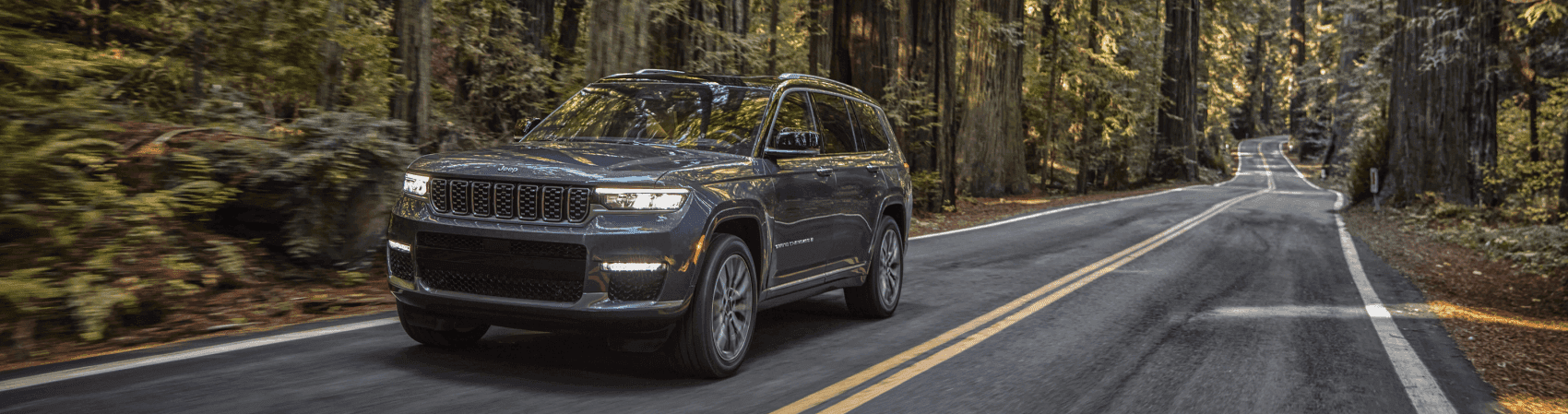 2021 Jeep Grand Cherokee Summit Granite Crystal Metallic Wooded Road