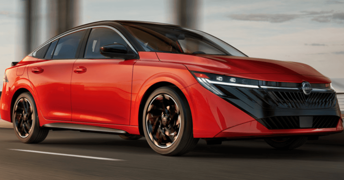 A red Nissan Sentra driving quickly down the road