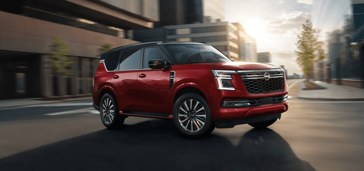 A red 2026 Nissan Armada Platinum Reserve turning at an intersection