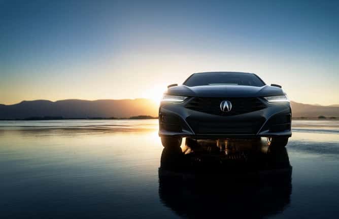 2024-Acura-TLX-parked-in-wet-desert-with-sunset-behind