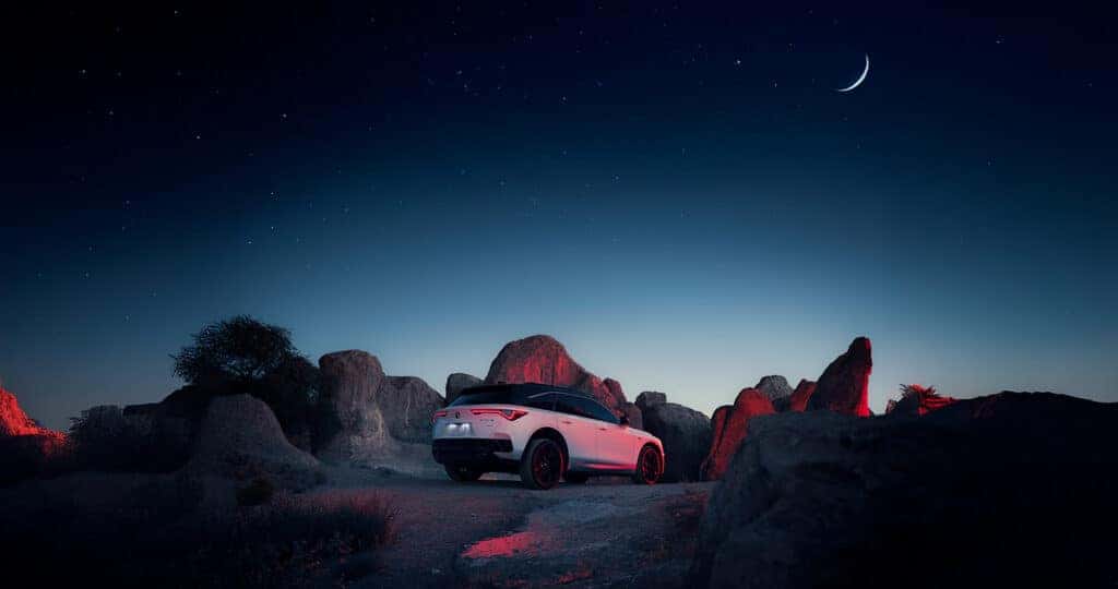 2024 Acura ZDX parked in the desert at night with stars and moon in sky