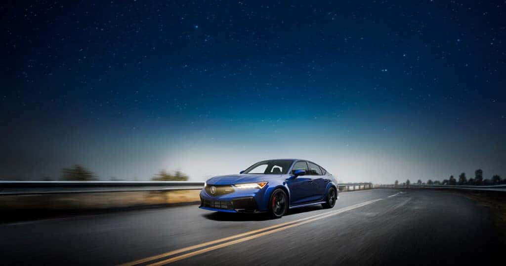 2025-Acura-Integra-Type-S-driving-on-a-wet-road-at-night-with-the-stars-above
