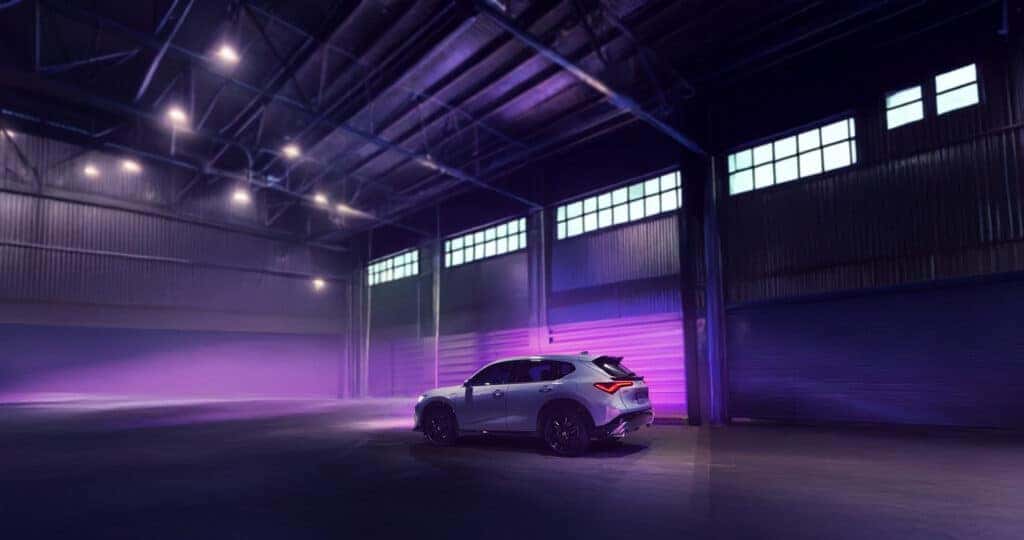 2025 Acura ADX A-Spec parked in a warehouse with purple lighting