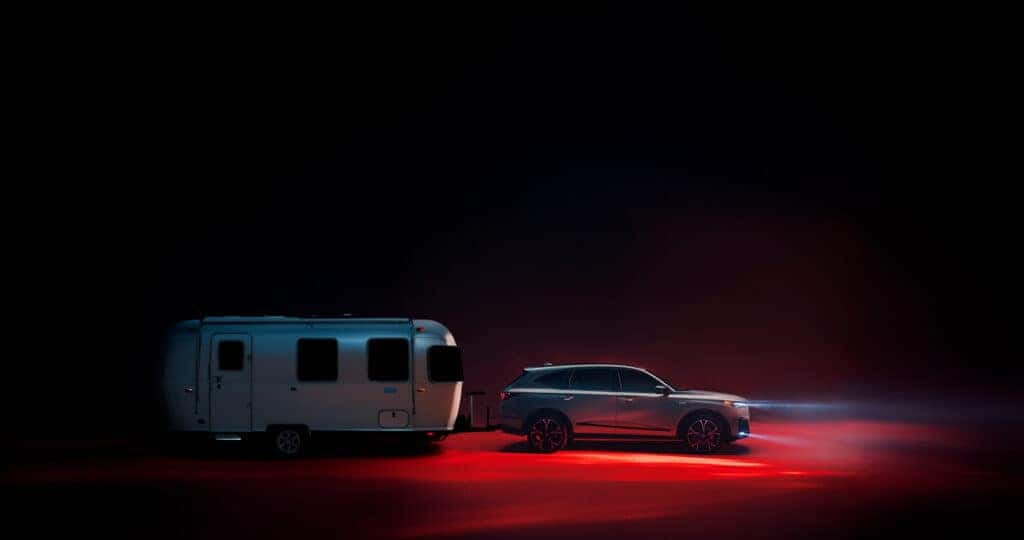 2026 Acura MDX towing an airsteam at night