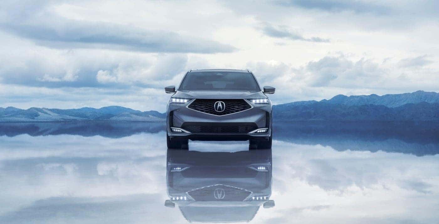 2026 Acura MDX front facing with water reflection below and mountains in the background