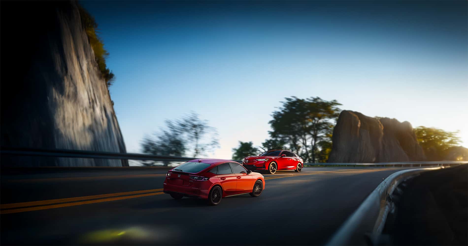 2026 Acura Integra vs Honda Civic Passing each other on a coastal winding road at sunset
