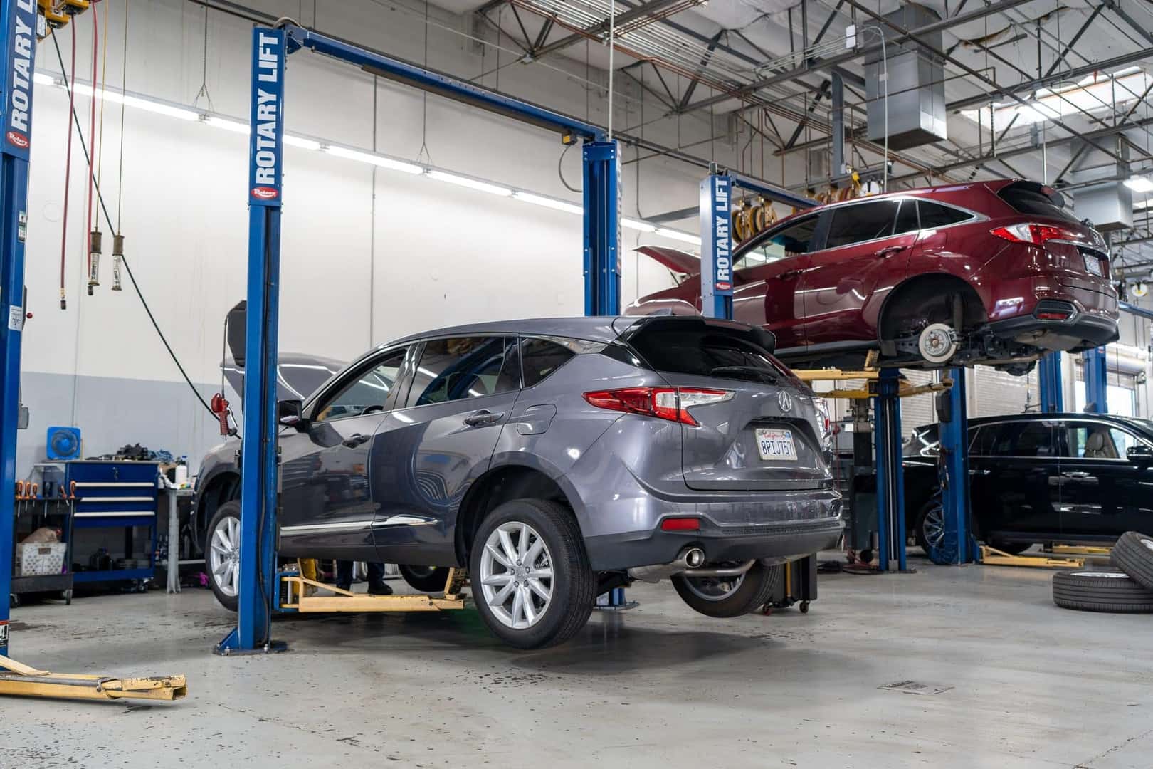 Acura RDX models raised on lifts in the Elk Grove Acura service shop