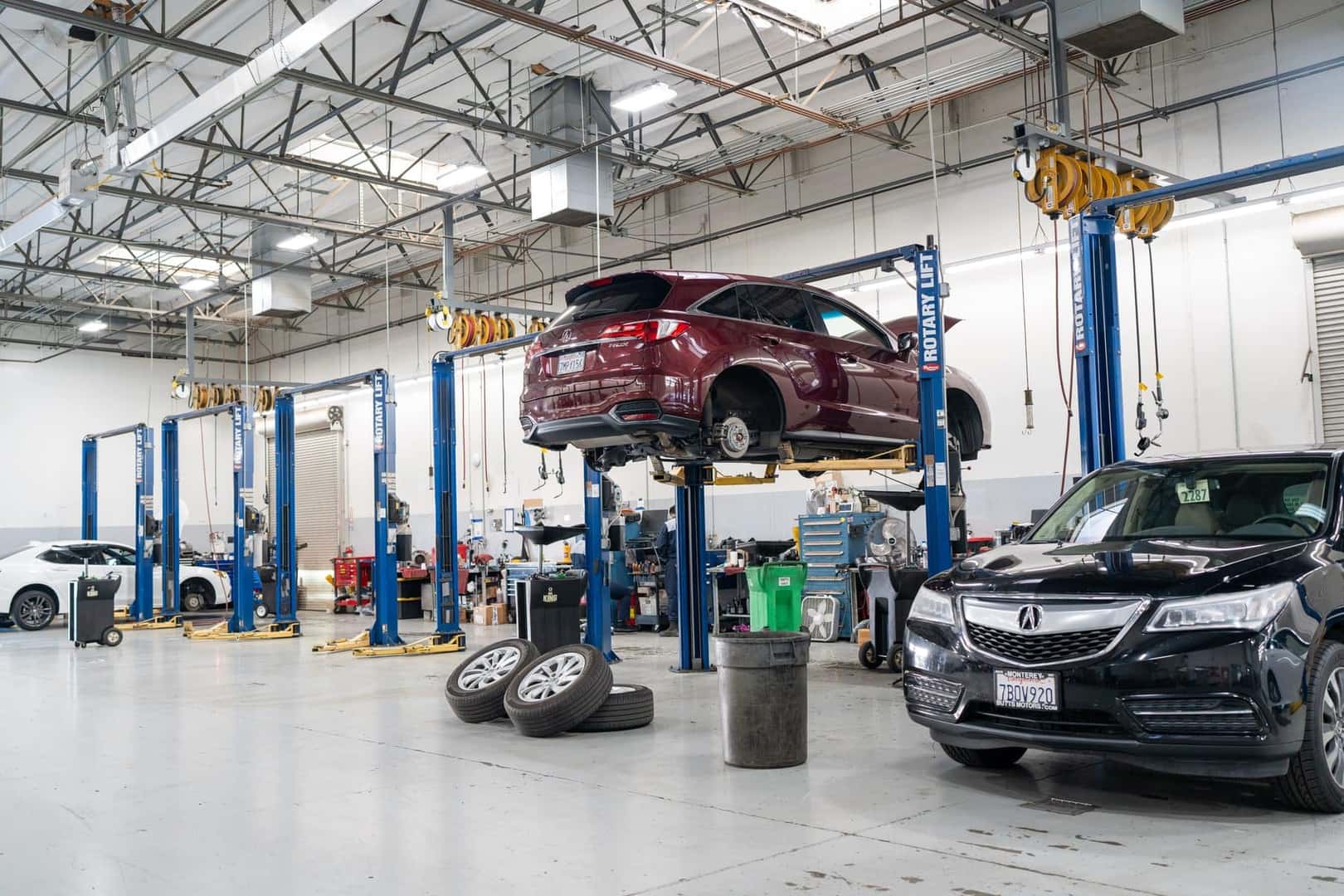The Elk Grove Acura service shop with vehicles raised on lifts across several bays