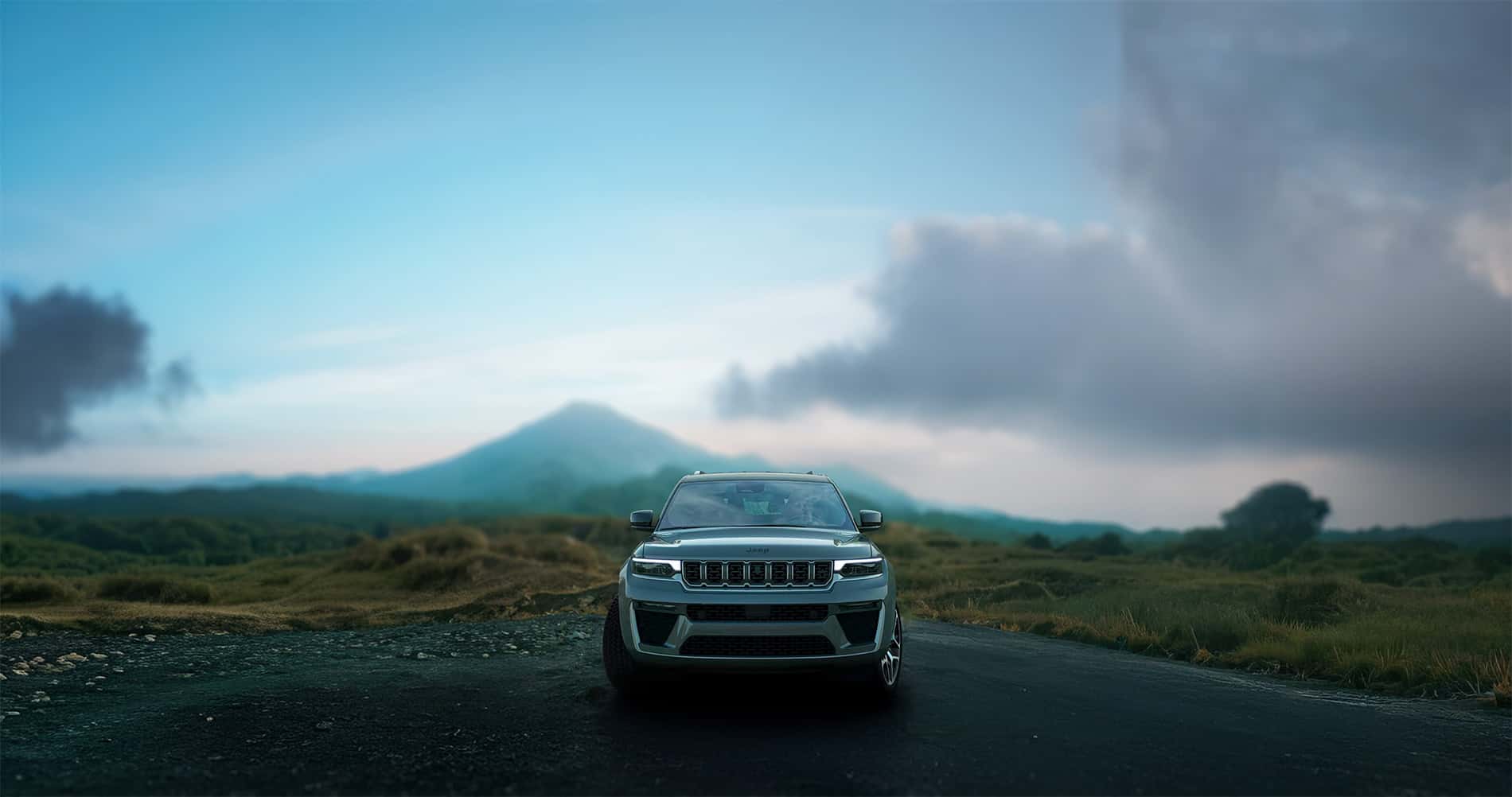 2026 Jeep Grand Cherokee Facelift being shown off in the wilderness with a mountain in the distance