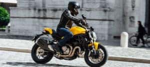Man riding yellow and black Ducati Monster