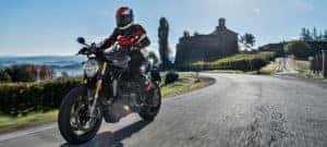 Motorcyclist riding Monster 1200S down scenic road