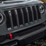 A close up of the iconic Jeep 7 slotted grille on a 2019 Jeep Wrangler.