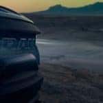 A closeup of the newest Ram truck, the 2021 Ram TRX, is shown while parked in a desert.