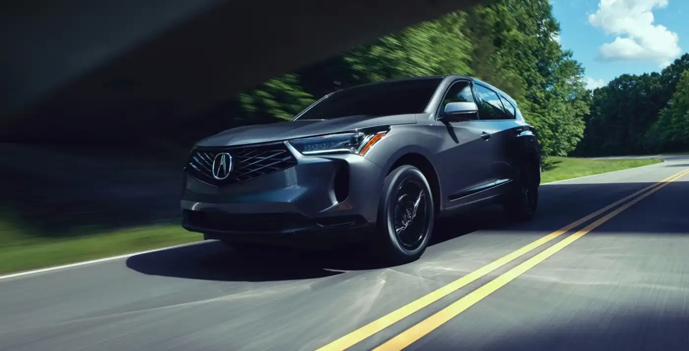 2025 Acura RDX in motion on a scenic road, highlighting its performance capabilities.