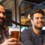 three people drinking craft beer at a brewery
