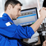 mechanic performs wheel alignment