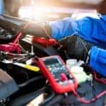 Technician testing a car battery