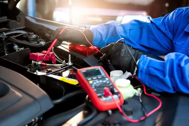 Technician testing a car battery