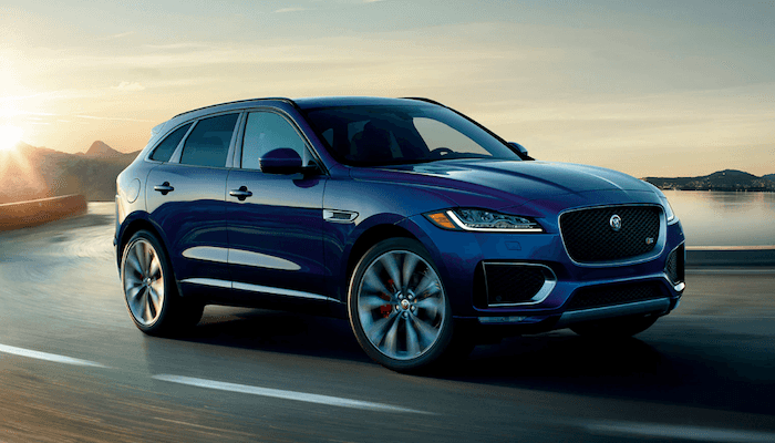 Blue 2020 Jaguar F-PACE driving on highway