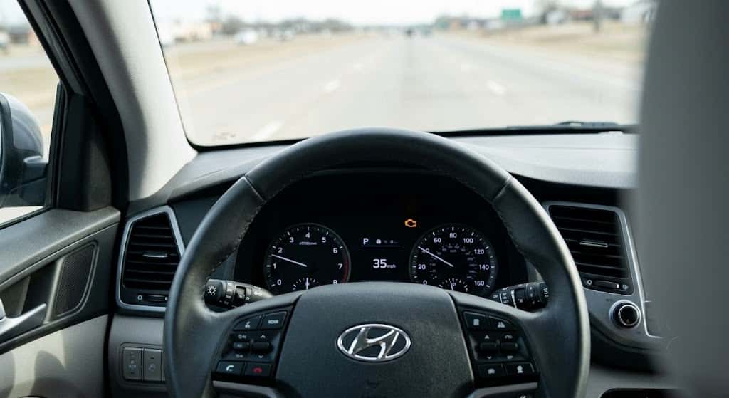 Hyundai dashboard with illuminated check engine light while driving
