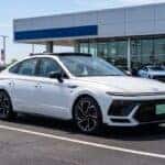 White 2026 Hyundai Sonata N Line parked outside James Hodge Hyundai dealership lot in Muskogee, showcasing aggressive sport sedan exterior styling