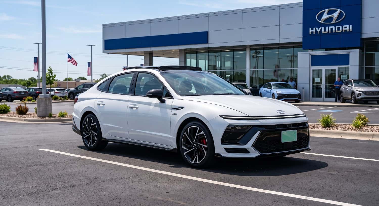White 2026 Hyundai Sonata N Line parked outside James Hodge Hyundai dealership lot in Muskogee, showcasing aggressive sport sedan exterior styling