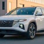 2026 Hyundai Tucson exterior parked on city street highlighting towing capacity specs