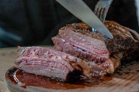 person cutting steak in cape girardeau, mo