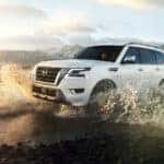 white nissan armada driving through large puddle
