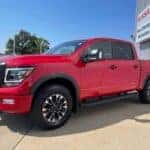 red 2024 nissan titan truck parked at John Sinclair Nissan in cape girardeau mo