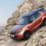 2019 land rover discovery descending down a rocky hill
