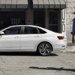 2020 VW Jetta parked on city street with couple nearby