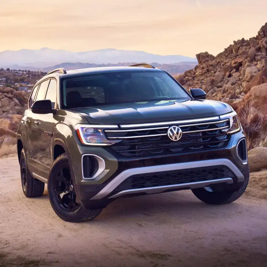 2026 Volkswagen Atlas SUV parked in desert mountain landscape, displaying front grille and LED headlights