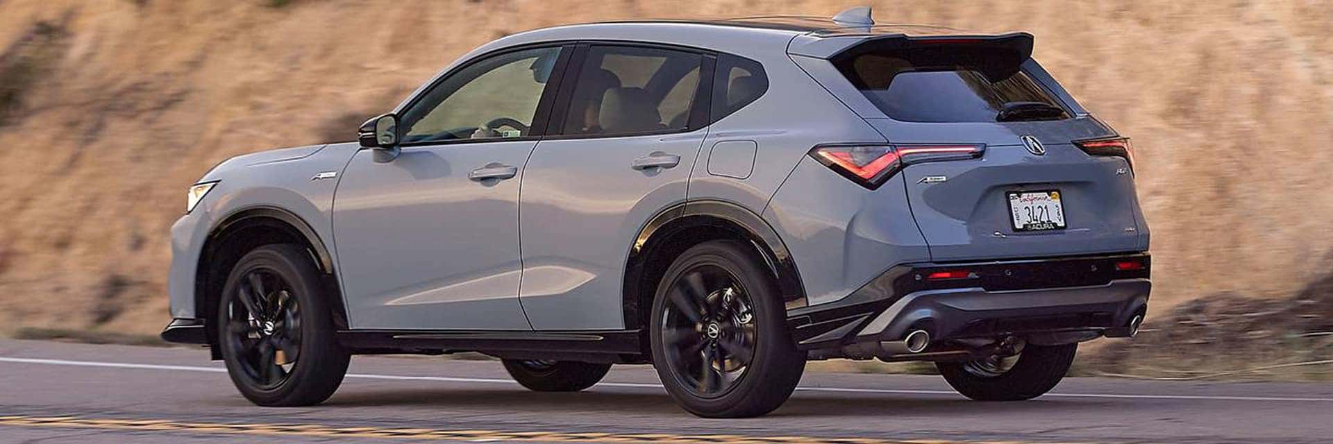 acura adx driving next to mountain