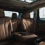 Acura MDX interior featuring leather-trimmed second-row seats, center armrest, and panoramic moonroof