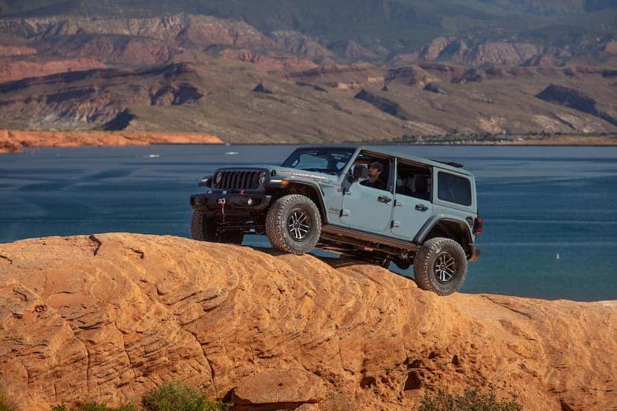 2025 Blue Jeep Wrangler Climbing a Mountain