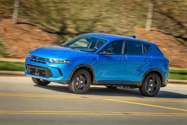 Blue Dodge Hornet R/T driving on road.